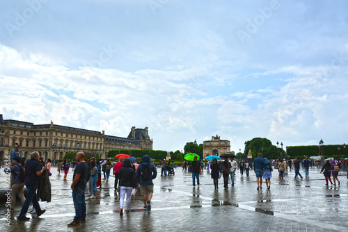 PARIS, FRANCE - MAY 25, 2019: Famous Paris Louvre. People in main courtyard (Cour Napoleon) 