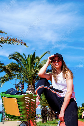 Girl on Bike with Palms in Batumi photo