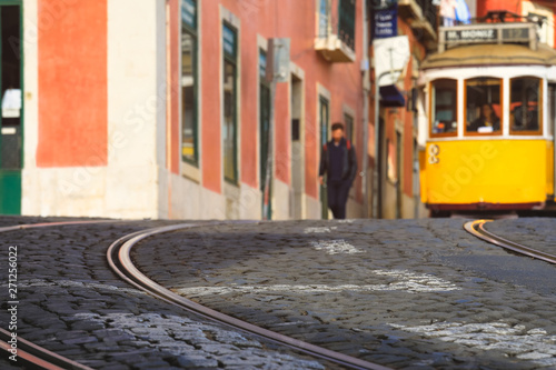 Selective focus on floor with blurred image of Street in the old district of the city, Lisbon, Portugal