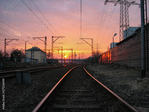 Railway infrastructure at sunset.