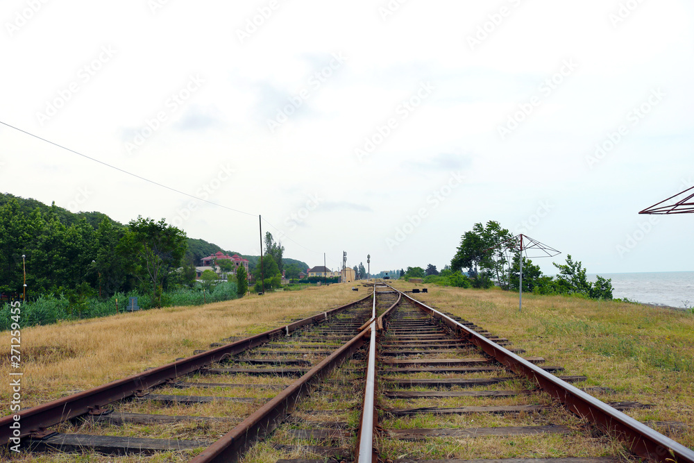 Obraz premium Two railway tracks merge together. Line of railway crossing. Detail of a railway tracks 