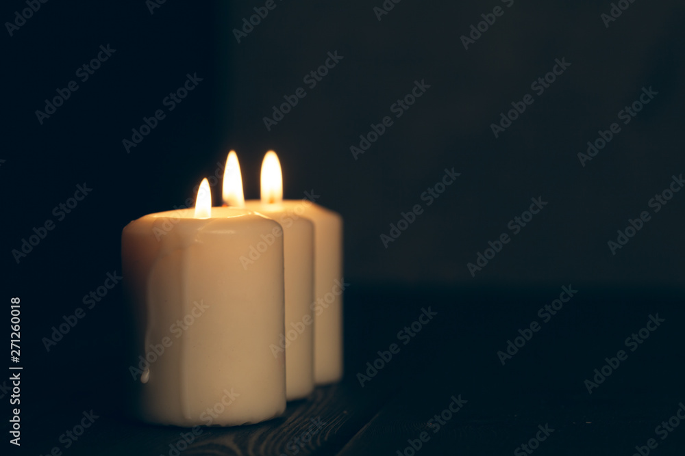 candles burning in darkness over black background. commemoration concept. candles burning in darkness over black background. commemoration concept.