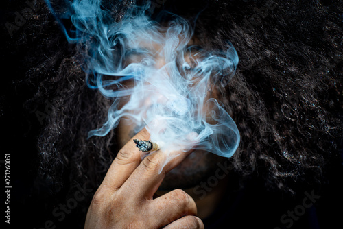Marijuana joint in the hand, Concepts of medical marijuana use and legalization of the cannabis.