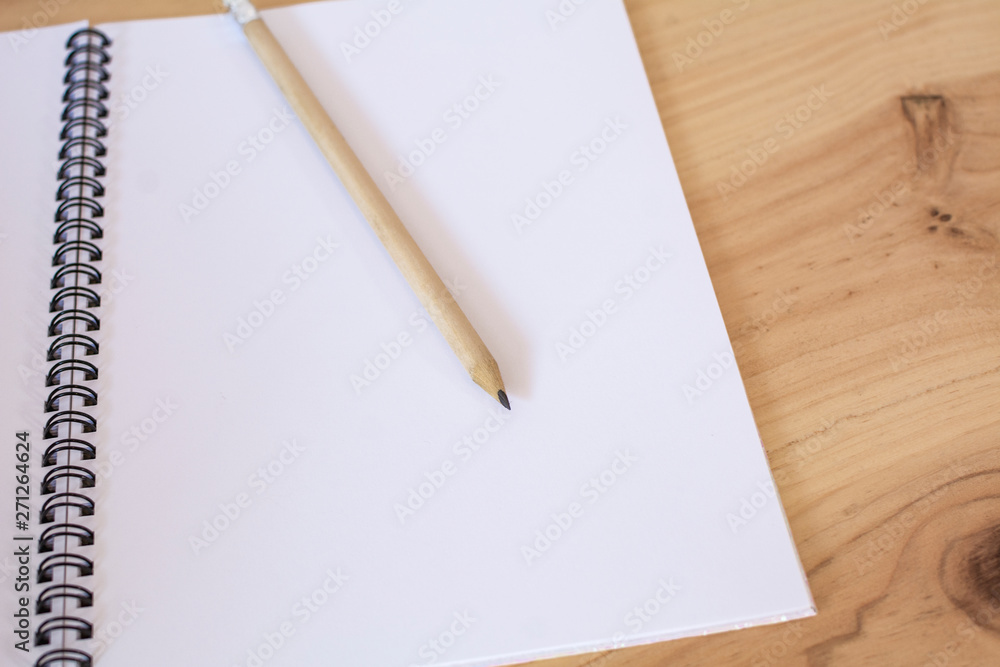 School notebook with pencil on the wooden table. Back to school. School notebook with pencil on the wooden table. Back to school.