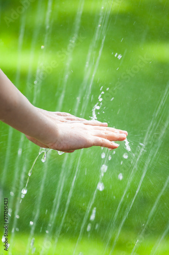 children hand water drop grass background 