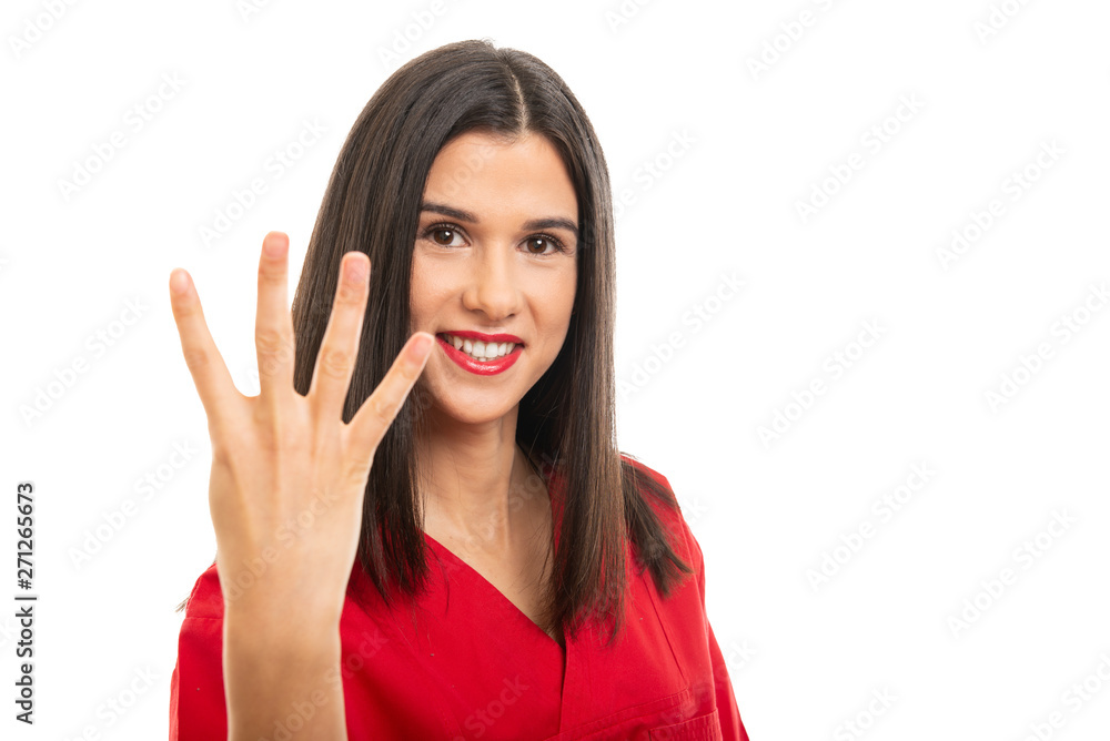Portrait of beautiful nurse wearing red scrubs showing number four gesture Portrait of beautiful nurse wearing red scrubs showing number four gesture