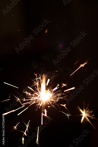 Burning party sparkler on black background