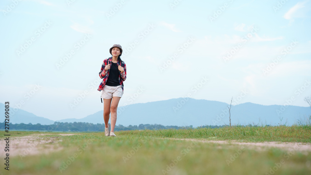 Asian young woman tourist backpack walk travel in the nature forest. Woman tourist walking in the nature on background mountain view. Asian young woman tourist backpack walk travel in the nature forest. Woman tourist walking in the nature on background mountain view.