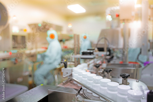 Transfer medicine bottles on the conveyor belt in the pharmaceutical industry, industrial machinery for the quality of medical products. Industrial concept and factory technology.shallow focus effect.