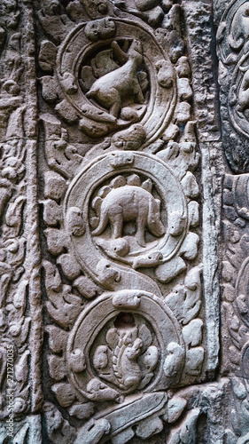 Close-up of dinosaur stone carving at one of the temples in Angkor Wat, which relates to Hindu and Buddish mythology and bearing Khmer and Dravidian architectural styles. (Angkor Wat, Cambodia)