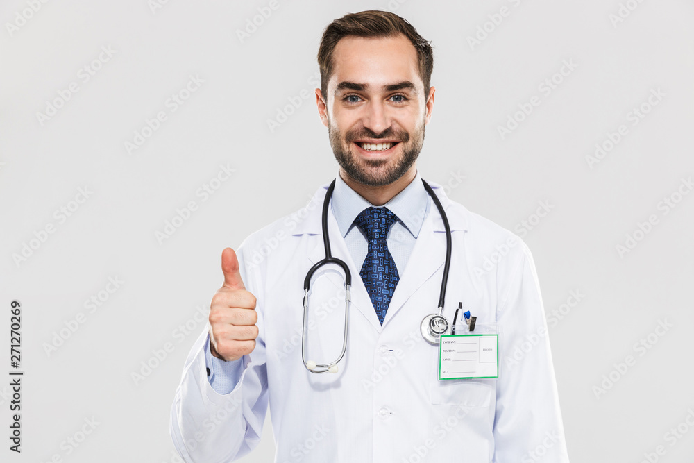 Portrait of happy young medical doctor with stethoscope smiling at camera and showing thumb up Portrait of happy young medical doctor with stethoscope smiling at camera and showing thumb up