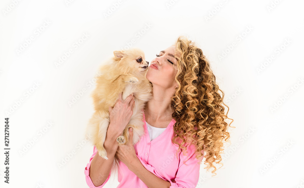 Friendship, love. Woman kisses sweet puppy. Love to animals. Sexy girl hugs  little dog. Adorable girl