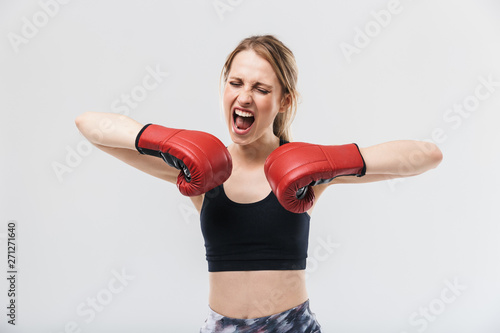 Image of delighted blond woman 20s dressed in sportswear and boxing gloves working out and during fitness in gym © Drobot Dean