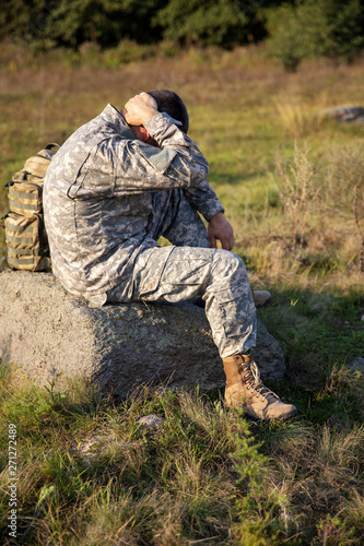 The soldier sits and rests. Sad soldier. Tired soldier.