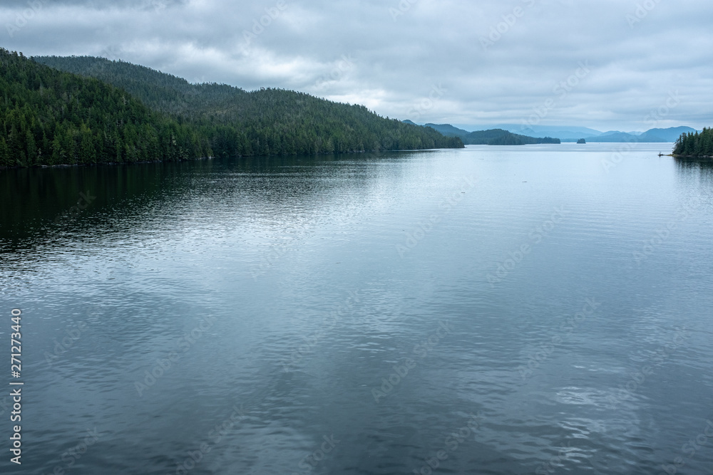 The  view at the top of Vancouver Island and the still calm waters as seen from the back of ferry as it starts it's journey up the Inside Passage, nobody in the image