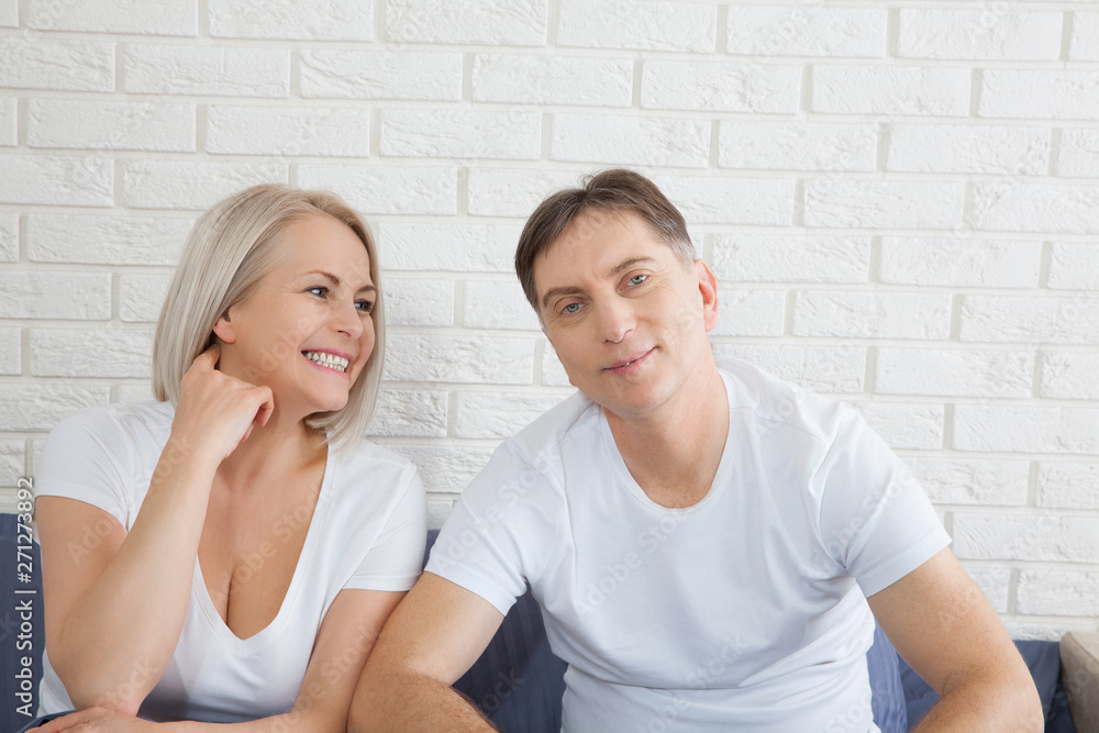 Happy couple is lying in bed together. Enjoying the company of each other. Happy couple is lying in bed together. Enjoying the company of each other.