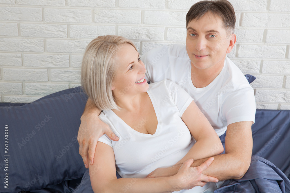 Senior couple at home. Handsome old man and attractive old woman are enjoying spending time together while lying in bed. Senior couple at home. Handsome old man and attractive old woman are enjoying spending time together while lying in bed.