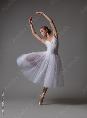Tela Ballerina dancing in white dress. Color photo.