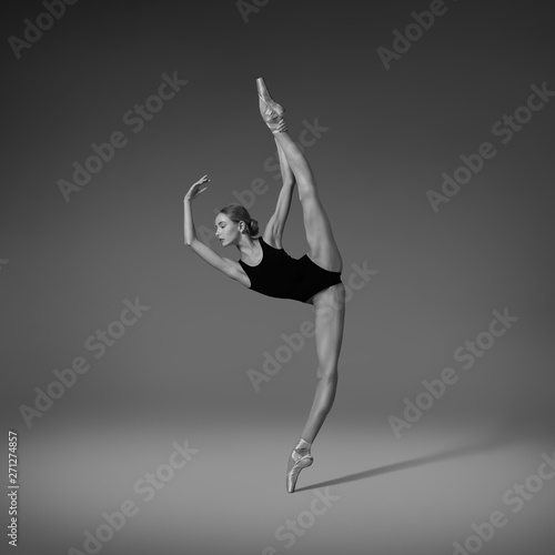  Ballerina doing vertical split. Black and white photo 