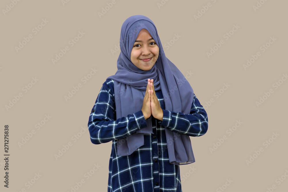 portrait of beautiful Muslim hijab woman congratulates Eid al-Fitr in front of the camera portrait of beautiful Muslim hijab woman congratulates Eid al-Fitr in front of the camera