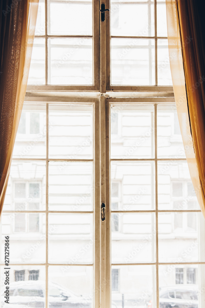 wooden window with vintage curtains and square molding on a sunny day. beige satin curtains. interior. background for collage
