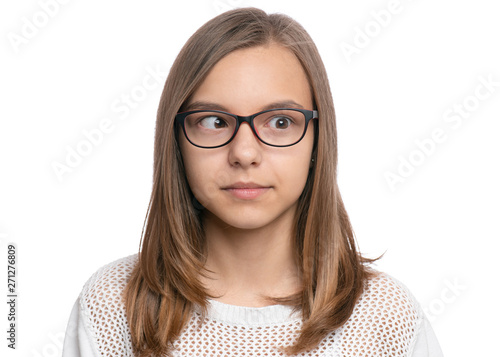 Crazy child making grimace - Silly face. Funny caucasian teen girl in eyeglasses, isolated on white background. Close-up portrait.