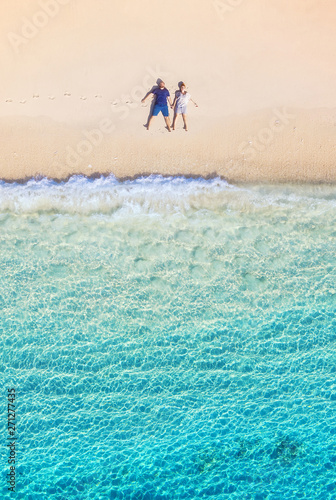 Photography Aerial view of a people couple on the beach on Bali, Indonesia