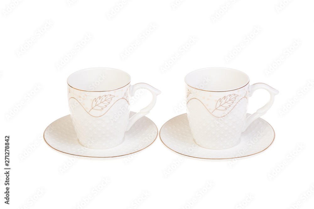 Two white porcelain tea, coffee cups with saucer. Isolated on white Two white porcelain tea, coffee cups with saucer. Isolated on white