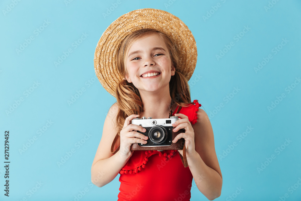 Cheerful little girl wearing swimsuit standing