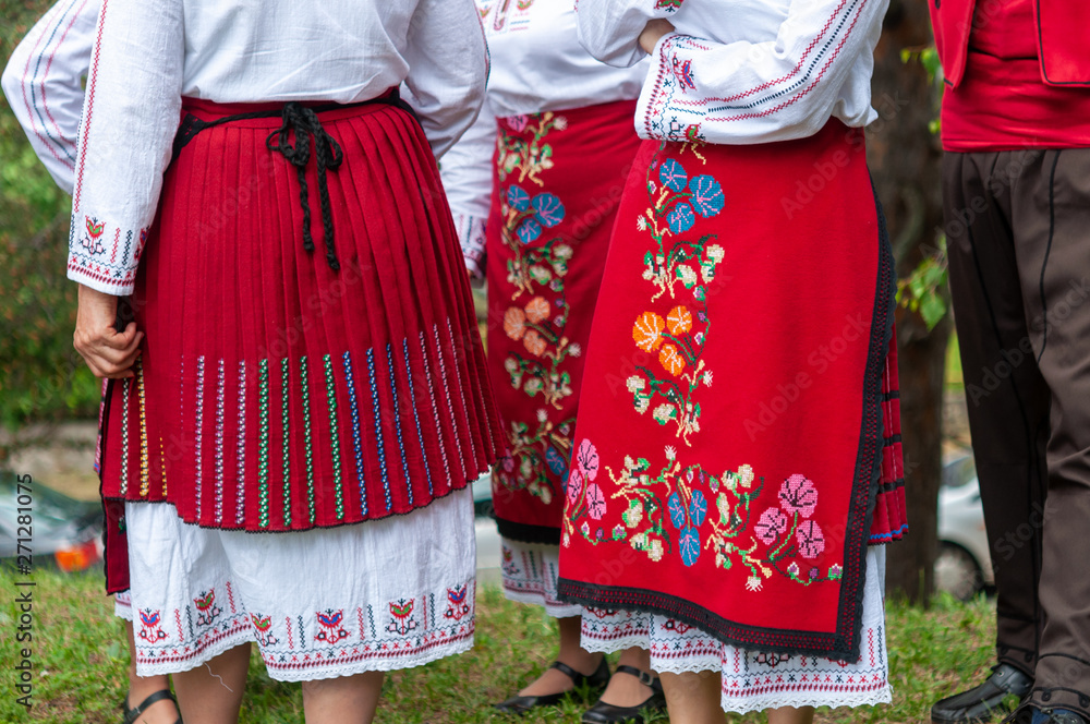 People in traditional costumes dance bulgarian