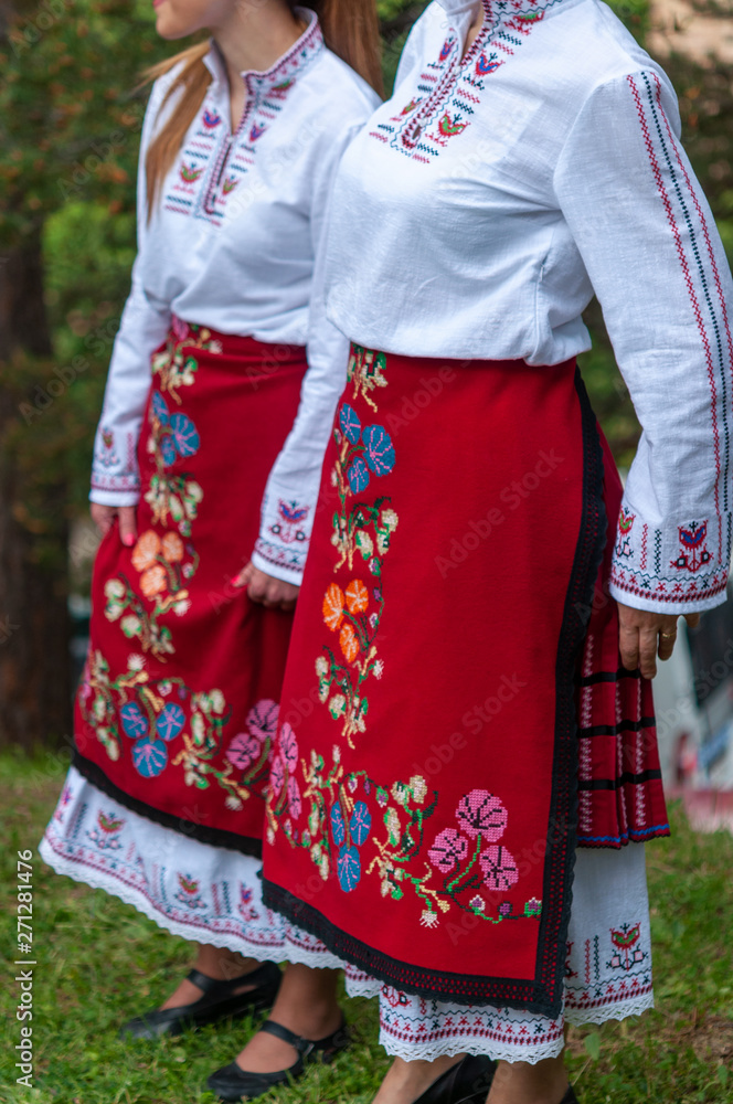 People in traditional costumes dance bulgarian People in traditional costumes dance bulgarian