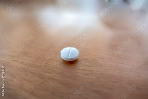 a lonely tablet lying on a wooden table