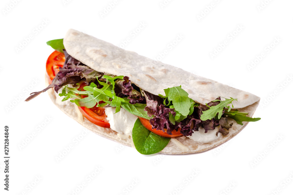 Obraz premium The concept of Italian cuisine. Vegatarian piadina with tomatoes, mozzarella cheese, mix lettuce, arugula and sauce on a white background. Isolate
