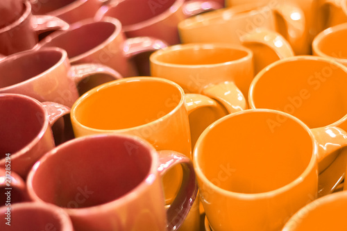 Many colorful empty ceramic cups in store, Mugs background