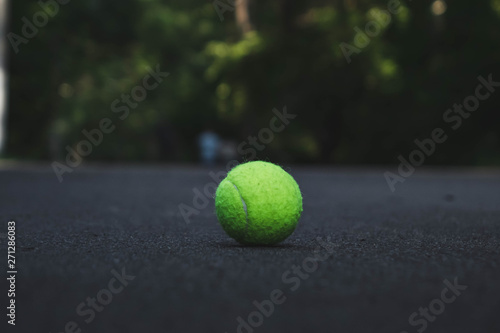 green tennis ball lying on the road © Влад Астанин