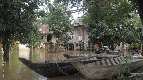 Wallpaper Mural close up on wooden boats in the front of stilt houses encircled by floodwaters Torontodigital.ca