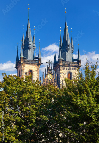 Wallpaper Mural Prague, Czech republic. Church of Our Lady Before Tyn cathedral. Top spires roof. Summer sunny day and blue sky with clouds. Green trees in front of building. Torontodigital.ca