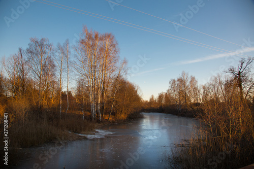 Autumn forest and frozen river in the sun in the Republic of Mariel Mariets © Artem