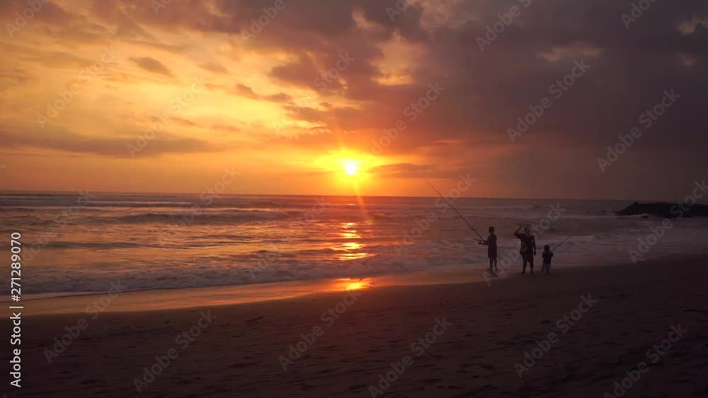 Silhouette of Fisherman with son and friend on beach. Colorful and bright beautiful sunset over the water. Soothing Andaman Sea off the coast of Krabi, Thailand. 50 frames per second, full HD footage. Silhouette of Fisherman with son and friend on beach. Colorful and bright beautiful sunset over the water. Soothing Andaman Sea off the coast of Krabi, Thailand. 50 frames per second, full HD footage.