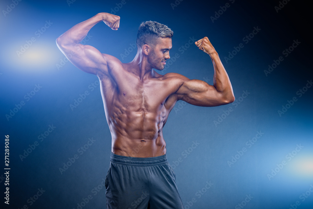Obraz premium Fit, Muscular Young Men Flexing Muscles