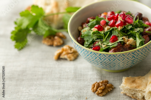 Traditional Georgian Lobio of Cooked Red Kidney Beans Containing Coriander, Walnut and Pomegranate seeds, close up, selective focus