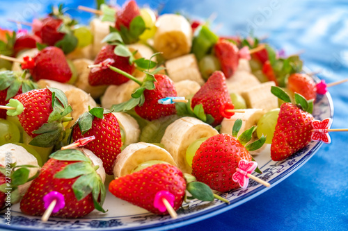 strawberries and other exotic fruits pinned with sticks