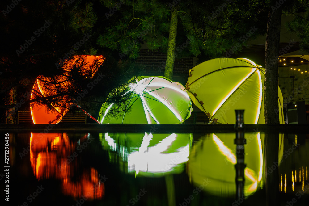 Colored umbrellas reflected in the water at night, Odessa, Ukraine