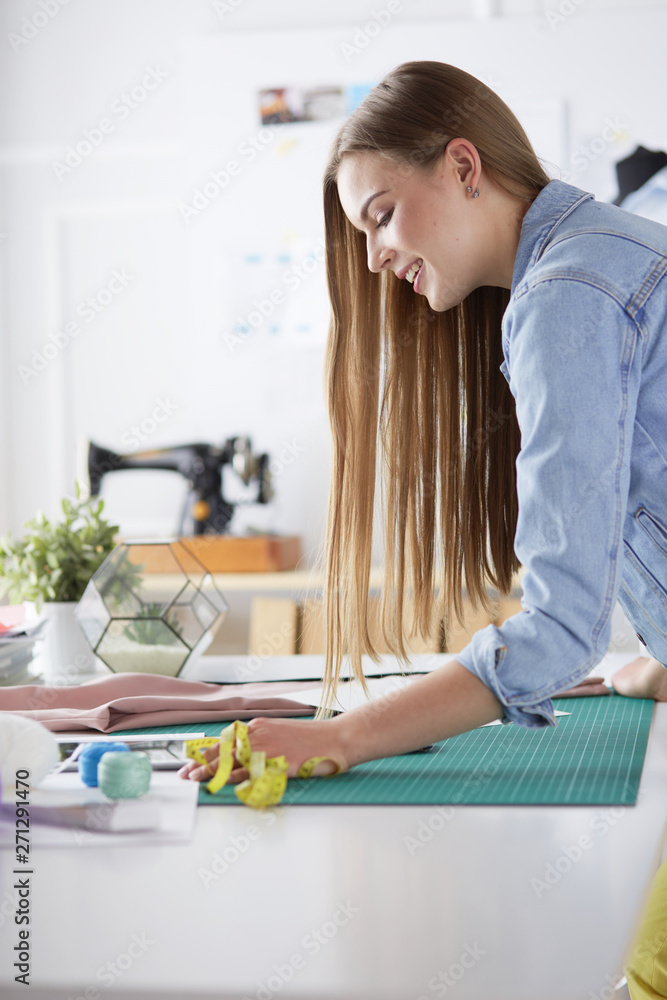 Woman American fashion designer working in atelier. Woman American fashion designer working in atelier.