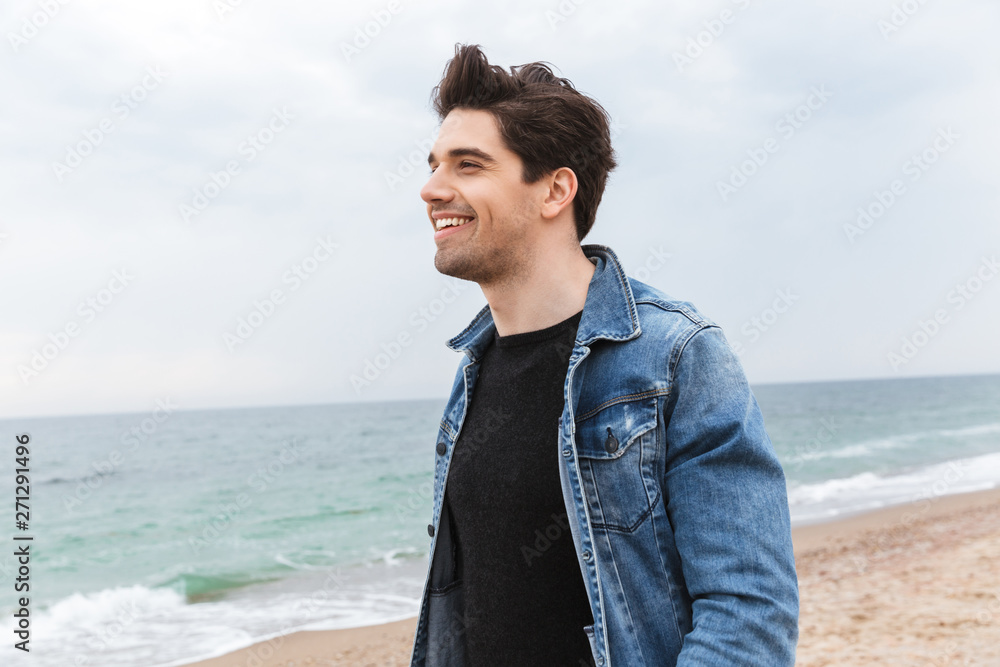 Attractive young man wearing denim jacket walking Attractive young man wearing denim jacket walking