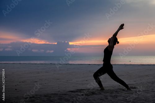 practise yoga on the beach in early morning.