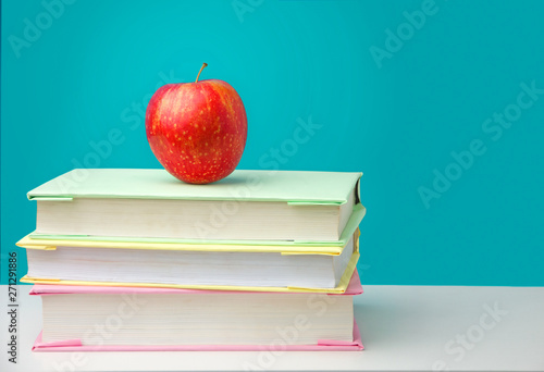 Stack of books with a red apple