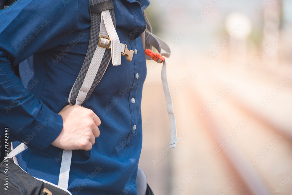 Part of body backpackers hold backpack at train station. Part of body backpackers hold backpack at train station.
