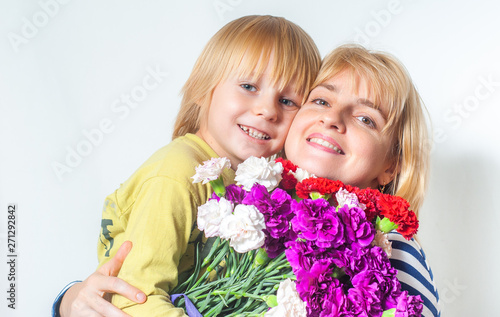 happy woman with son and bouquet of flowers