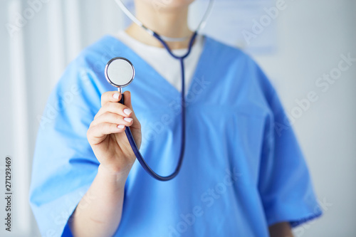 Young and confident male doctor with stethoscope in his hands. Successful doctor career concept © lenets_tan